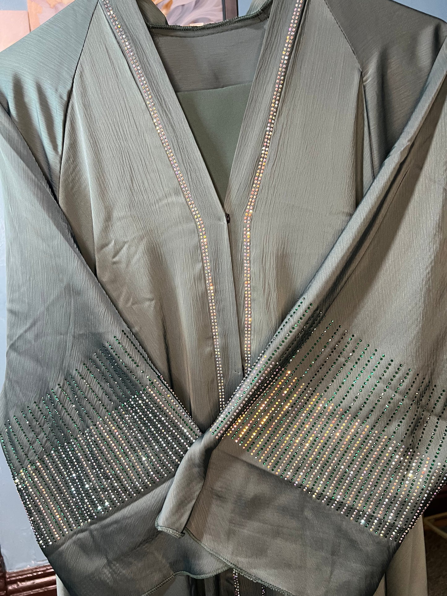 Teal-colored abaya with intricate rhinestone