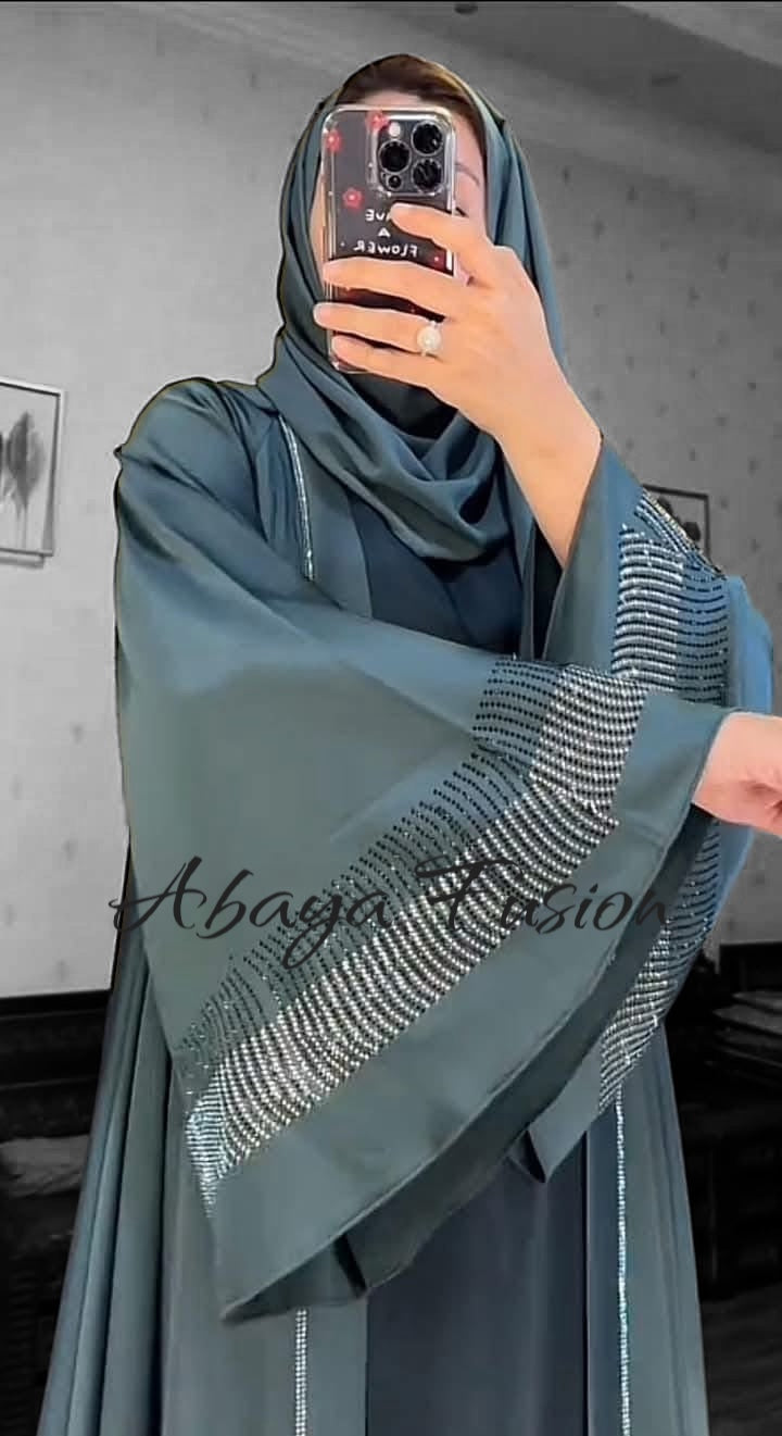Teal-colored abaya with intricate rhinestone
